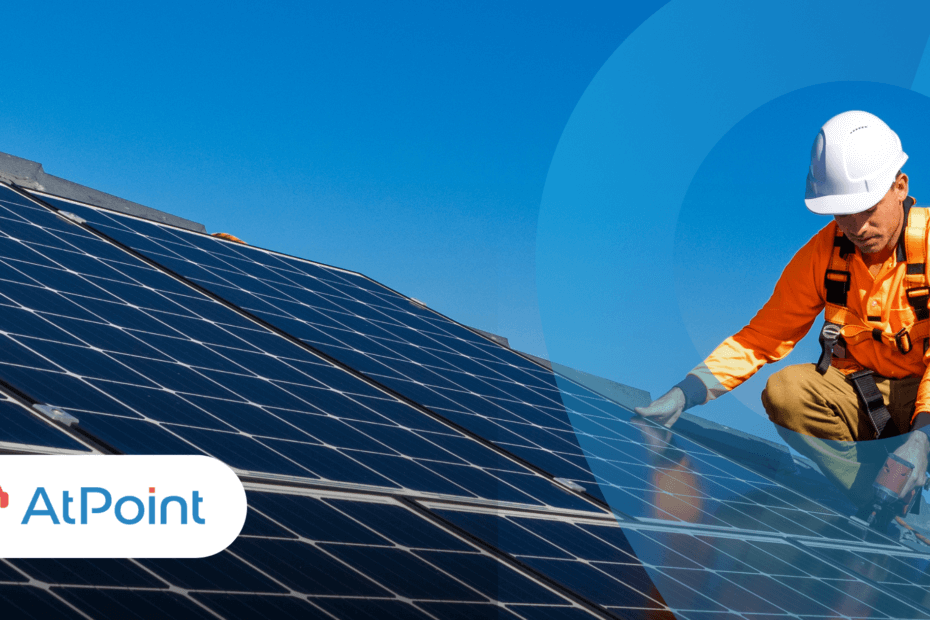 A professional installer working on a solar panel on a bright clear day.